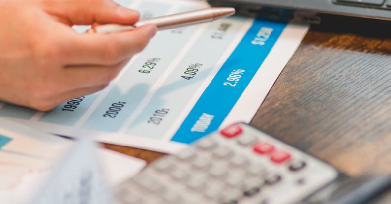 Interest Rates - A Close-Up Shot of an Agent Pointing Rates with a Ballpen