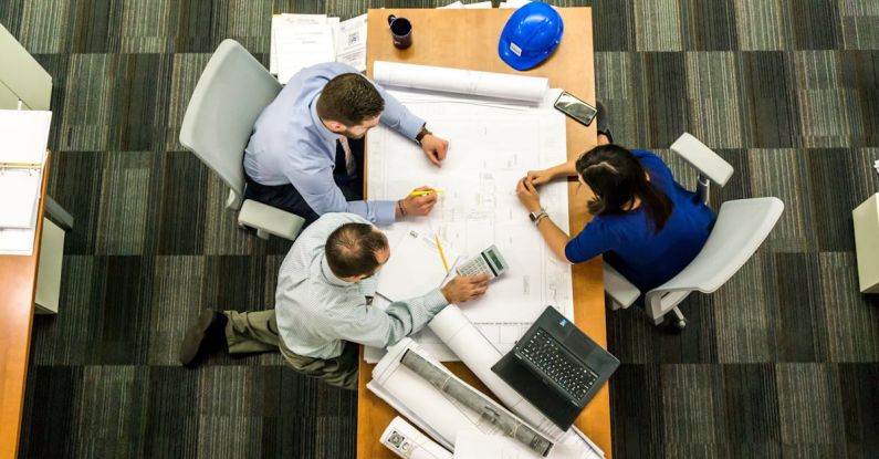 Risk Management - Three People Sitting Beside Table